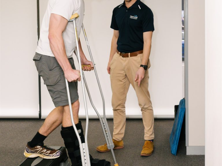 Learning to use crutches and moon boot from a Physio